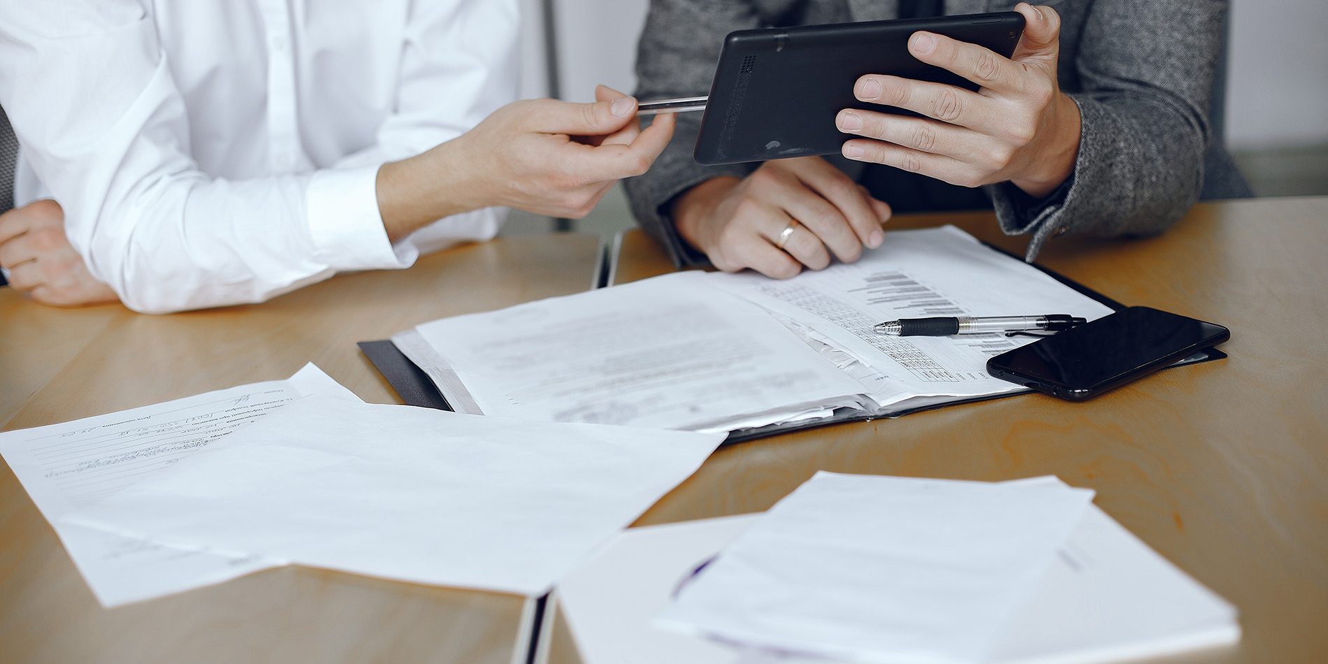 Two business partners signing a document