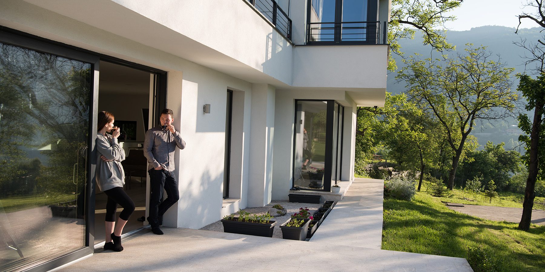 couple enjoying on the door of their luxury home villa