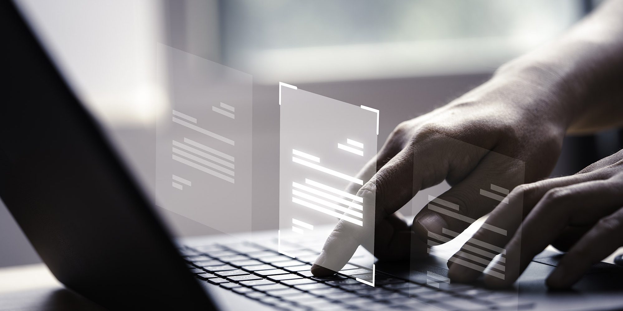 Hand using laptop computer with virtual screen and document for