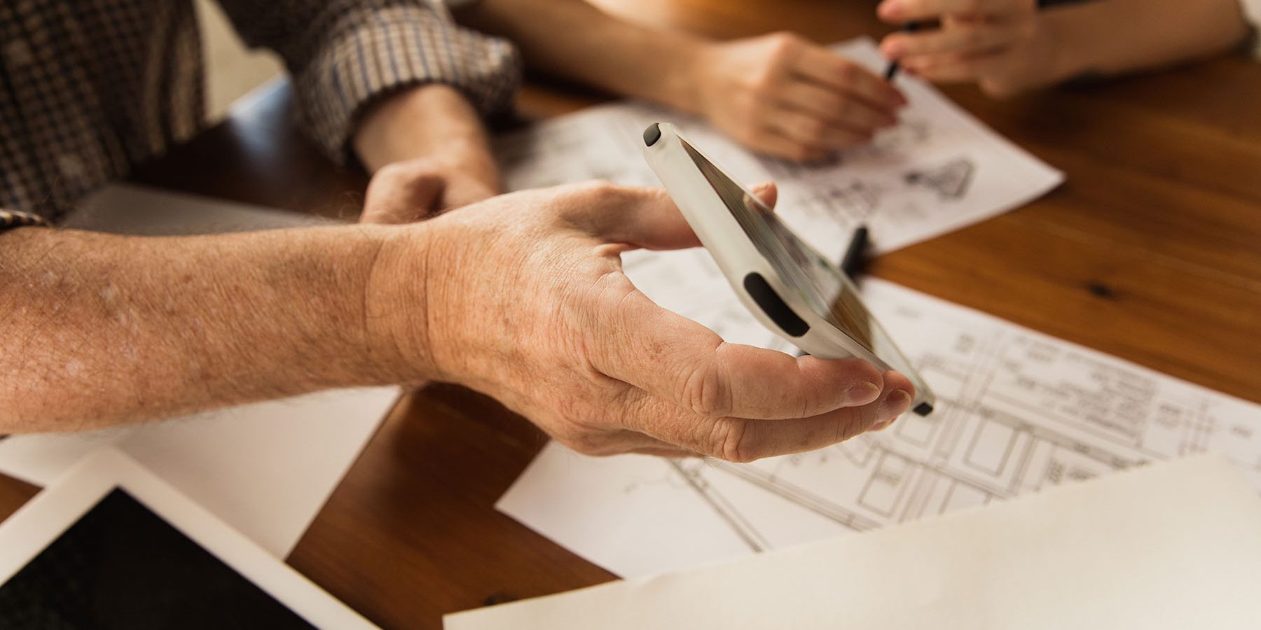 Male architect-engineer presents project of future house for young family.